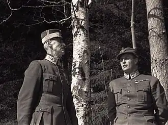 Crown Prince Olav and his father King Haakon VII take shelter under birch trees as the German Luftwaffe bombs Molde.