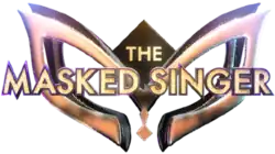 The words "The Masked Singer" in a gold-colored, capitalized typeface appearing in front of a 3D mask design